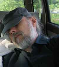 Photo of gray-bearded guy pretending to be asleep under Boston Herald baseball cap.