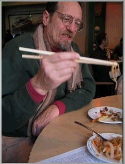 silly picture of, yes, a man eating jellyfish, with chopsticks